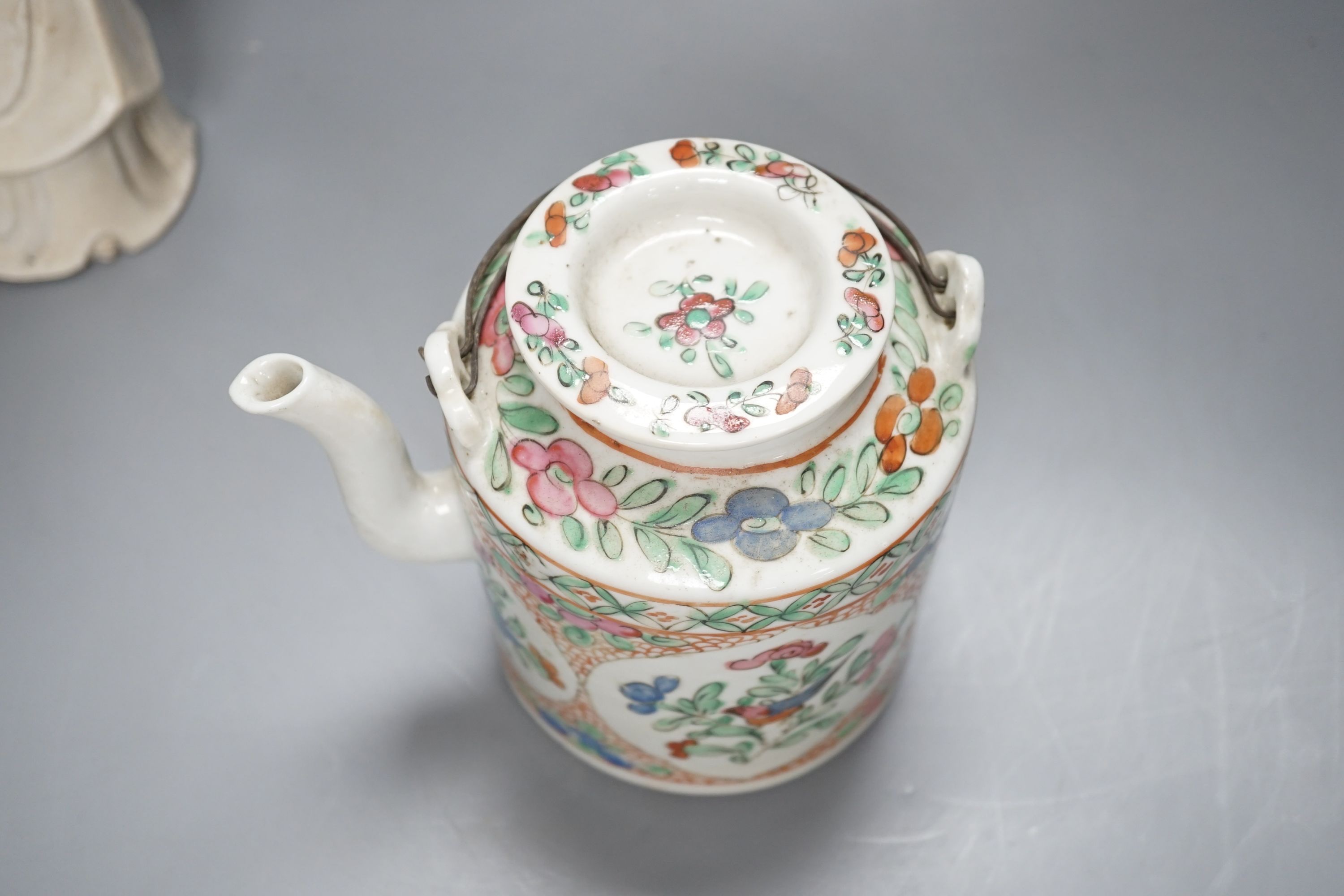 A Chinese blanc de chin figure of a lady with a bird, 37cm, together with a famille rose teapot, a yixing style teapot, blue and white jar and cover and a pale celadon ground ‘ox head’ libation cup